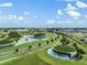 Scenic aerial view showcases the community's pristine landscaping and water features at 10381 Tupper Cay Dr, San Antonio, FL 33576