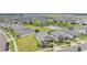 Wide aerial view of the neighborhood showcasing the houses and a pond at 10381 Tupper Cay Dr, San Antonio, FL 33576