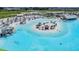 Lagoon with a sandy beach, lounge seating, and recreational water activities for residents at 10381 Tupper Cay Dr, San Antonio, FL 33576