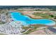 Stunning aerial view of a lagoon with beach, waterpark, and community amenities at 10381 Tupper Cay Dr, San Antonio, FL 33576