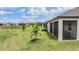 Spacious backyard featuring a screened patio and lush green lawn, perfect for outdoor activities at 10381 Tupper Cay Dr, San Antonio, FL 33576