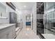 Stylish bathroom with double vanity, marble countertops, tiled floors, and modern shower at 10381 Tupper Cay Dr, San Antonio, FL 33576