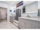 Elegant bathroom featuring double sinks, marble countertops, ample storage, and modern fixtures at 10381 Tupper Cay Dr, San Antonio, FL 33576