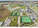 Aerial view showcasing a community featuring a pool, clubhouse, and tennis courts at 10381 Tupper Cay Dr, San Antonio, FL 33576