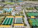 Aerial view of community amenities, including a pool, clubhouse, tennis courts, and bocce ball at 10381 Tupper Cay Dr, San Antonio, FL 33576
