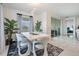 Open-concept dining room featuring marble floors, pendant lighting, modern table, and natural light at 10381 Tupper Cay Dr, San Antonio, FL 33576