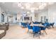 Upscale clubhouse dining room featuring modern lighting fixtures and stylish blue chairs at 10381 Tupper Cay Dr, San Antonio, FL 33576
