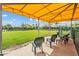 Dog park with green grass, seating, and a yellow sunshade at 10381 Tupper Cay Dr, San Antonio, FL 33576