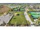 Aerial view of a fenced dog park with covered seating and green space at 10381 Tupper Cay Dr, San Antonio, FL 33576