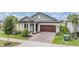 Charming single-Gathering home with a well-manicured lawn, paved driveway, and attached two-car garage at 10381 Tupper Cay Dr, San Antonio, FL 33576