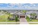 Charming single-Gathering home with a well-manicured lawn, palm trees, and a two-car garage at 10381 Tupper Cay Dr, San Antonio, FL 33576