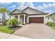 Charming single-Gathering home featuring a beautiful brick driveway, well-manicured landscaping, and a two-car garage at 10381 Tupper Cay Dr, San Antonio, FL 33576