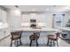 Bright and airy kitchen with a central island, stainless steel appliances, stylish bar stools, and a dining area at 10381 Tupper Cay Dr, San Antonio, FL 33576