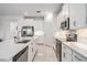 Modern kitchen featuring sleek stainless steel appliances, white cabinets, and a spacious island for dining and entertaining at 10381 Tupper Cay Dr, San Antonio, FL 33576
