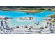 Aerial view of the lagoon showcasing the sandy beach, water slides, and in-water activities at 10381 Tupper Cay Dr, San Antonio, FL 33576