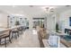 Bright, open-concept living room with neutral tones, sleek modern furniture, and access to the outdoor patio at 10381 Tupper Cay Dr, San Antonio, FL 33576
