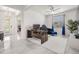 Bright living room with a home office and a view of the front entry at 10381 Tupper Cay Dr, San Antonio, FL 33576