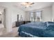 Bright main bedroom with a dresser, large windows, and cozy chair create a serene retreat at 10381 Tupper Cay Dr, San Antonio, FL 33576