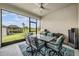 Outdoor patio with furniture, ceiling fan, and screened enclosure offering a comfortable view of the backyard at 10381 Tupper Cay Dr, San Antonio, FL 33576