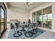 Covered patio with a dining table set, grill, and a ceiling fan for outdoor enjoyment at 10381 Tupper Cay Dr, San Antonio, FL 33576