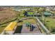 Aerial view of playground and tennis courts near scenic ponds and walking paths at 10381 Tupper Cay Dr, San Antonio, FL 33576