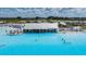 Breathtaking view of the large pool with a bar area and plenty of space for swimming and sunbathing at 10381 Tupper Cay Dr, San Antonio, FL 33576