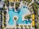 Aerial view of a resort-style pool with palm trees and lounge chairs at 10381 Tupper Cay Dr, San Antonio, FL 33576