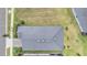Overhead view of a home showing its roof, landscaping, driveway, and surrounding lawns at 10381 Tupper Cay Dr, San Antonio, FL 33576