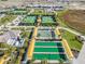 Aerial view of tennis and bocce ball courts with yellow awnings at 10381 Tupper Cay Dr, San Antonio, FL 33576