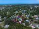 Aerial view of a property highlighting the home, pool, lush landscaping, and surrounding neighborhood at 10875 131St St, Largo, FL 33774