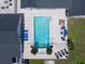 Aerial view of the backyard pool, patio with outdoor furniture and lounge chairs at 10875 131St St, Largo, FL 33774