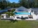 Aerial view of backyard pool, patio, outdoor furniture, and lawn at 10875 131St St, Largo, FL 33774