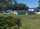 Aerial view showcasing a large backyard with a pool, patio area, and lush greenery at 10875 131St St, Largo, FL 33774