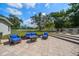 Backyard patio features outdoor seating and a landscaped lawn at 10875 131St St, Largo, FL 33774