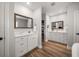Dual sink bathroom vanity with a hardwood floor and white cabinets at 10875 131St St, Largo, FL 33774