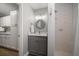 Bathroom with granite vanity, white tile shower, and modern lighting at 10875 131St St, Largo, FL 33774