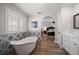 Bathroom with a soaking tub and decorative tile, with a view to the bedroom at 10875 131St St, Largo, FL 33774