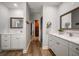 Bathroom with dual vanities, hardwood floors, and walk-in closet at 10875 131St St, Largo, FL 33774