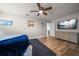 Well-lit bedroom with beach themed decor, ceiling fan and wood-look flooring at 10875 131St St, Largo, FL 33774