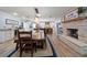 A well-lit dining room featuring a fireplace and an adjacent kitchen with modern white cabinets at 10875 131St St, Largo, FL 33774