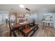 A spacious dining room with a fireplace, natural light, and wood flooring at 10875 131St St, Largo, FL 33774