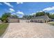 Paver driveway featuring a fire pit, seating area, and ample parking space at 10875 131St St, Largo, FL 33774