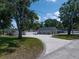 Long driveway leading to a well-maintained home, with landscaping and a recreational vehicle at 10875 131St St, Largo, FL 33774