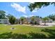 Charming single-story home featuring a well-manicured lawn, landscaping, and a curved walkway at 10875 131St St, Largo, FL 33774