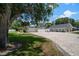 Long brick driveway with spacious lawn leading to single-story homes at 10875 131St St, Largo, FL 33774