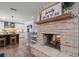 Cozy stone fireplace separating the kitchen and dining area with Gathering themed decor above the mantel at 10875 131St St, Largo, FL 33774