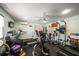 Bright home gym featuring a treadmill, weight machines, free weights, and ceiling fan for effective workouts at 10875 131St St, Largo, FL 33774