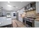 Well-equipped kitchen with stainless steel appliances, mosaic backsplash, and plenty of counter space at 10875 131St St, Largo, FL 33774