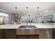 Close-up of the kitchen island featuring a stainless steel sink, modern faucet, and ample countertop space at 10875 131St St, Largo, FL 33774