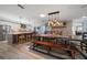 A expansive open layout featuring both the kitchen with island seating and a dining room set adjacent to a fireplace at 10875 131St St, Largo, FL 33774
